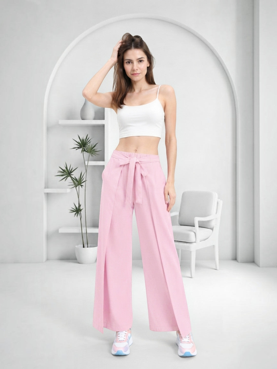 Pink wide-leg pants with front tie, paired with white crop top and pastel sneakers for trendy women's fashion