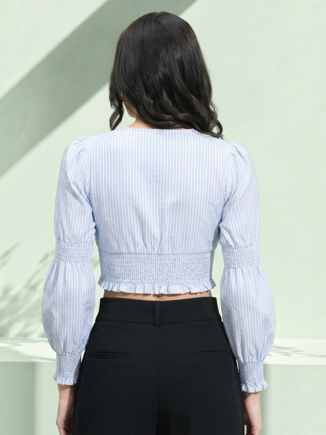 Striped crop top with puff sleeves and smocked back, paired with black high-waist pants