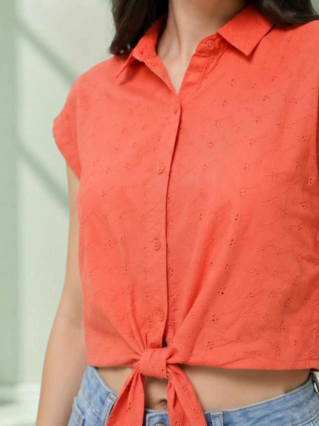 Coral tie-front button-up shirt with eyelet detail, styled with jeans for women's fashion