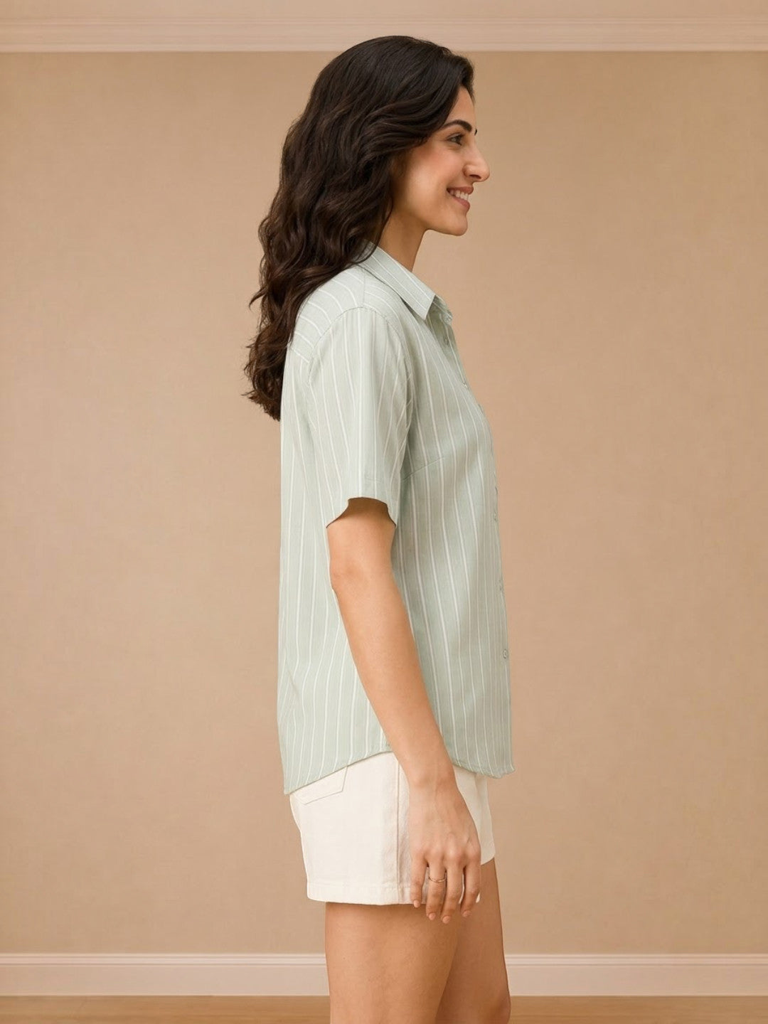 Woman in mint green striped short sleeve shirt with white shorts, casual summer outfit