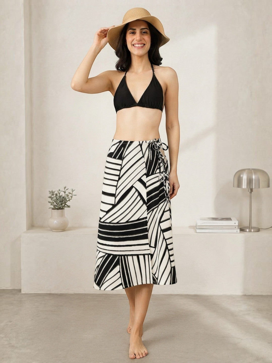 Black and white striped wrap skirt with halter top and straw hat