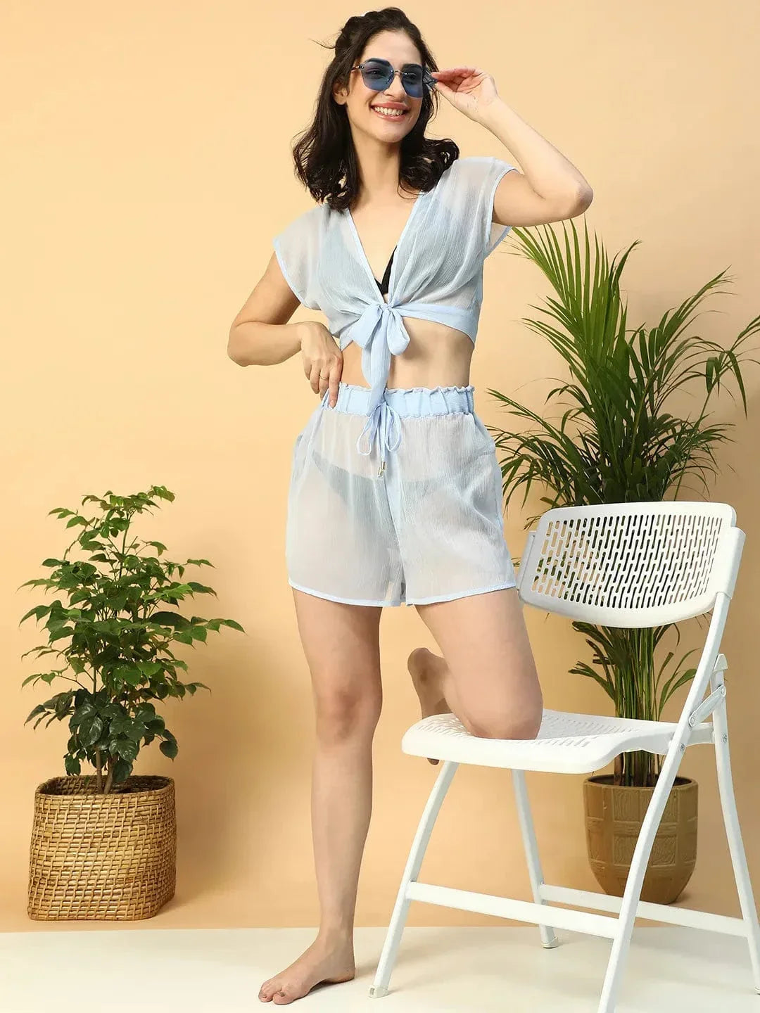 A woman wearing a pair of white shorts with a ruffled waistband.