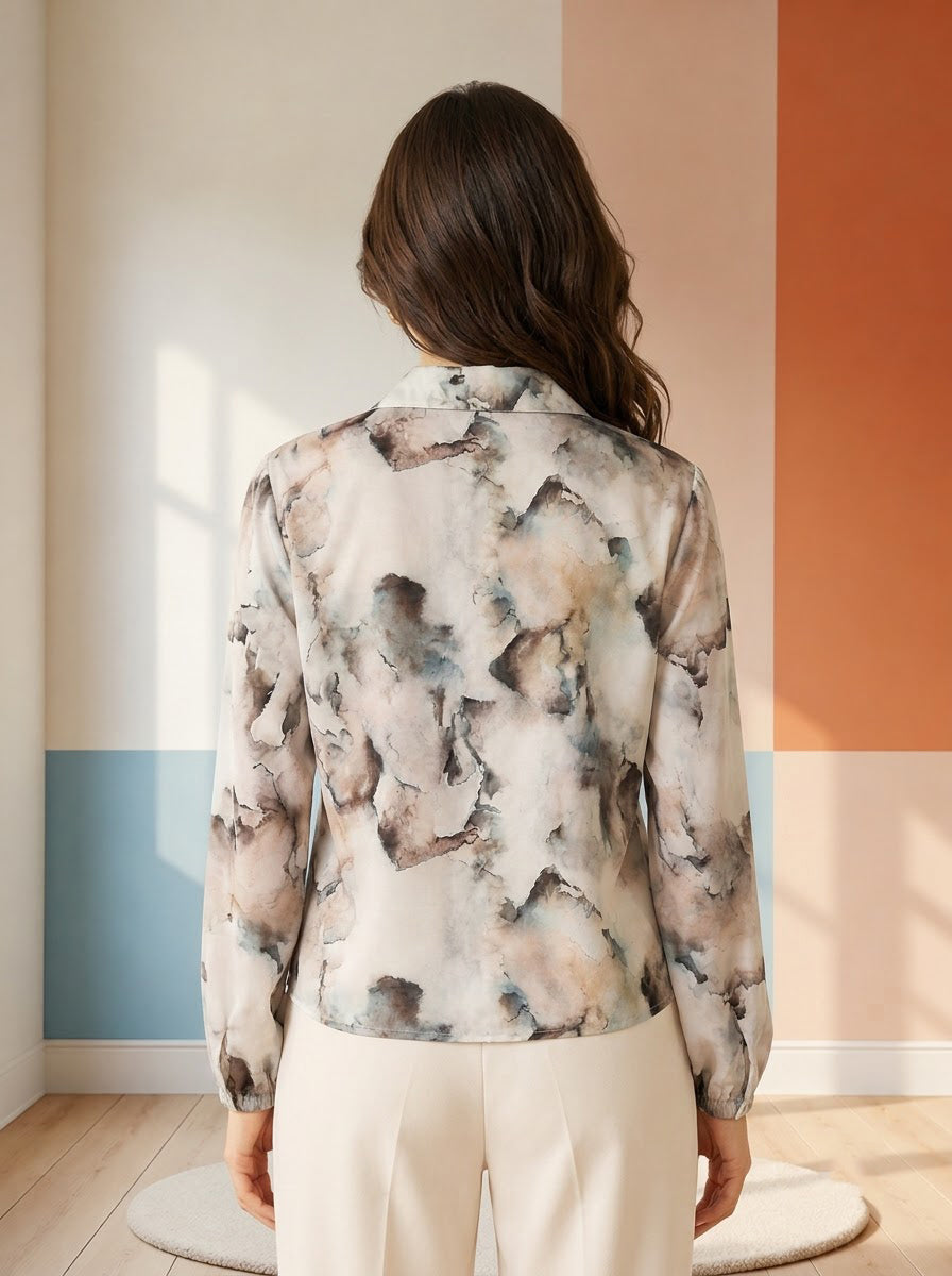 Woman wearing abstract print long sleeve blouse, back view, plus size fashion