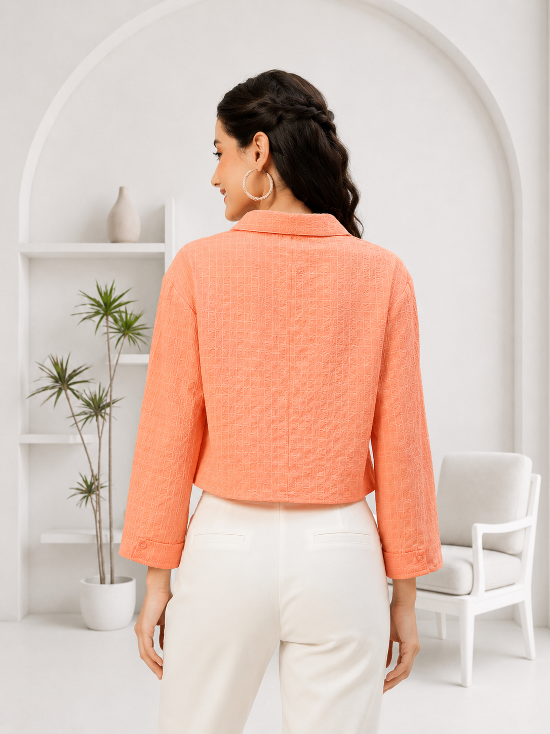 Woman in coral textured cropped blazer with white pants, stylish plus size fashion outfit