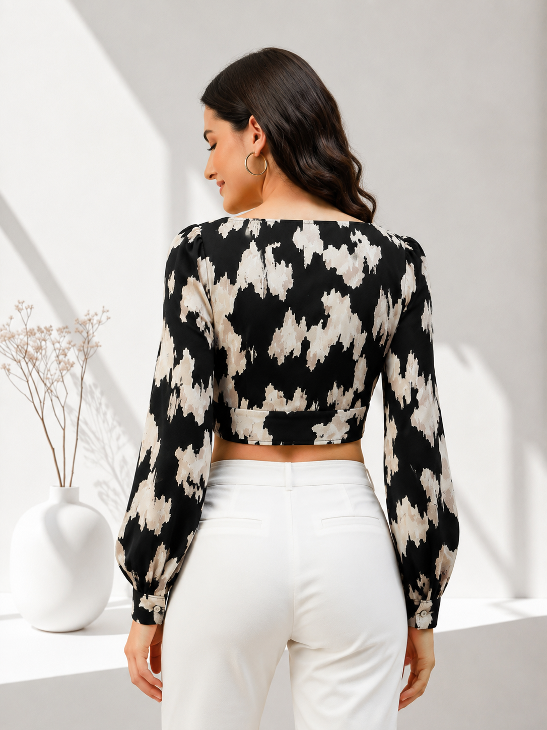 Black and beige abstract print crop top with long sleeves, paired with white pants for women's fashion