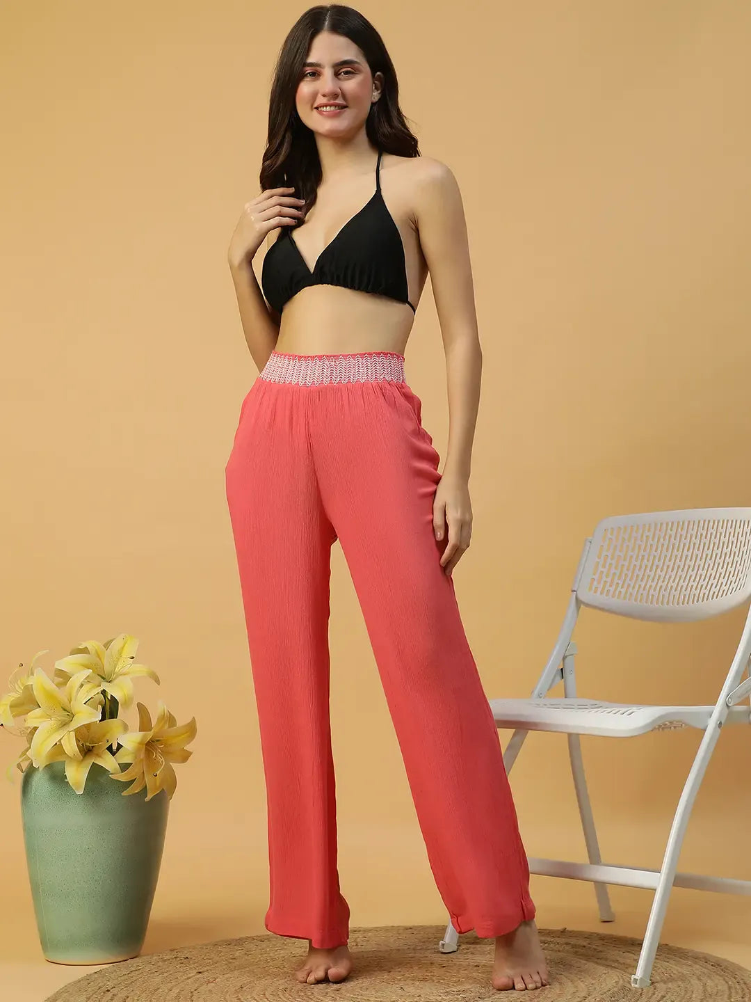 A woman wearing bright red wide leg pants.