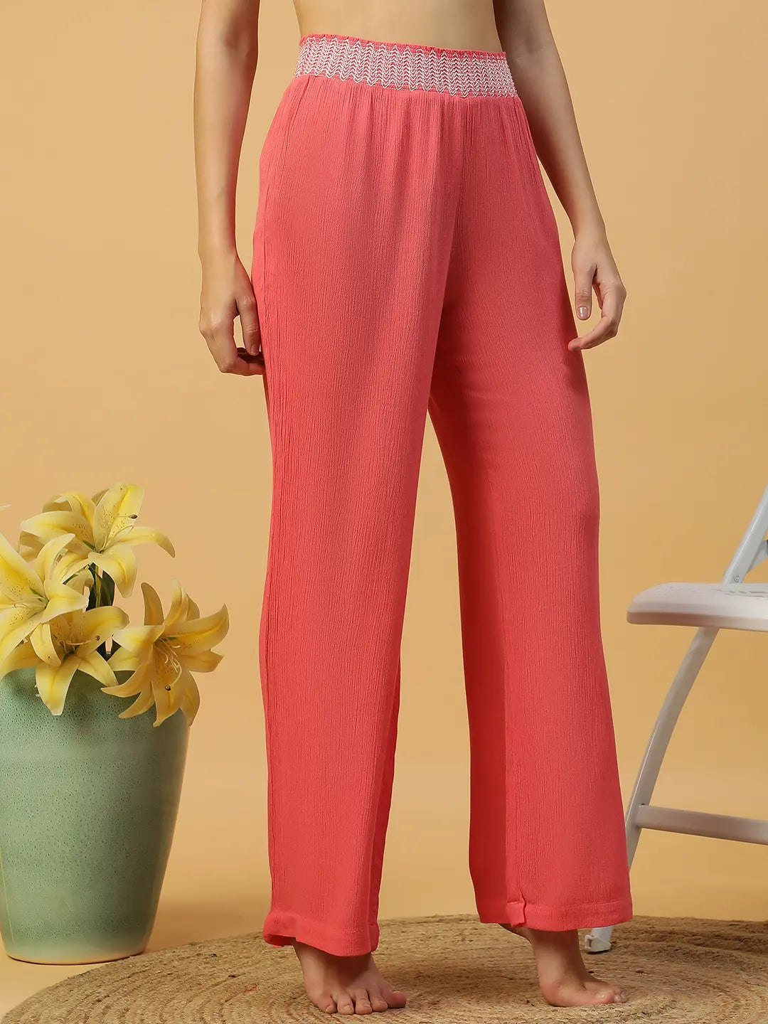 A woman wearing bright red wide leg pants.