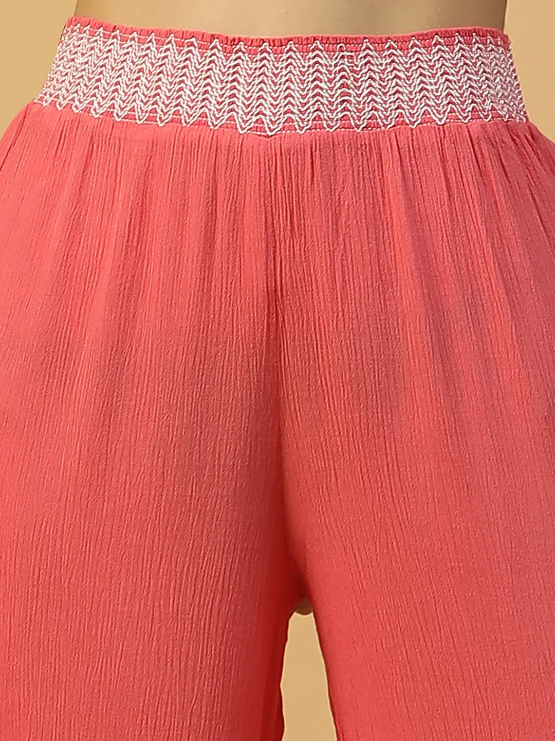 A woman wearing bright red wide leg pants.