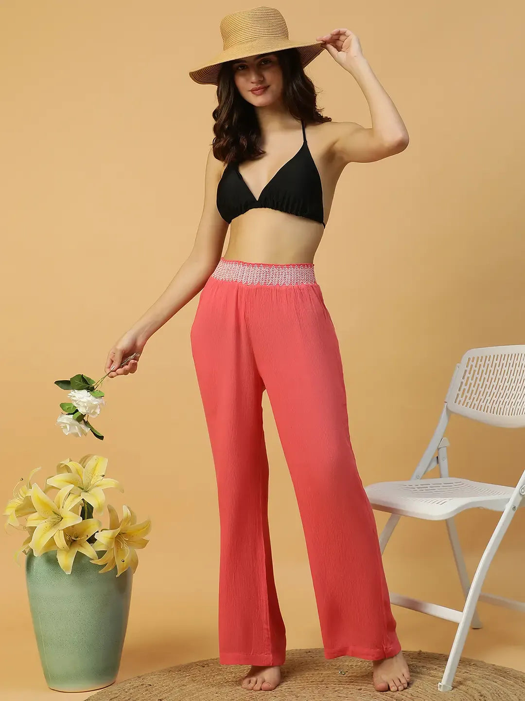 A woman wearing bright red wide leg pants.