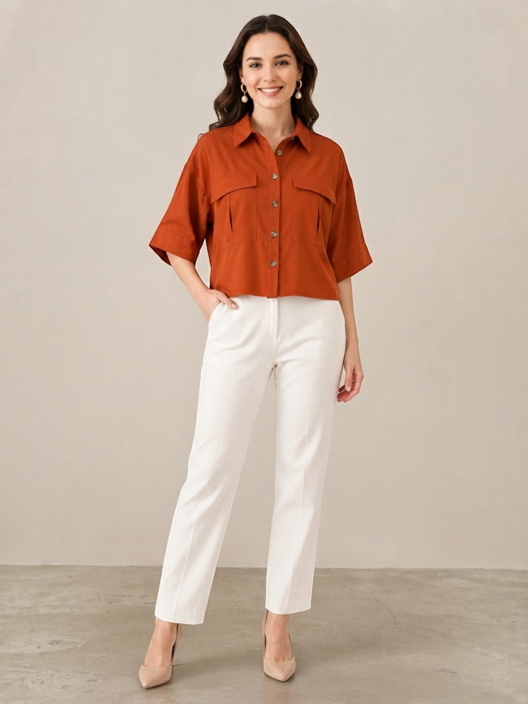 Rust button-up shirt with chest pockets paired with white straight-leg pants for women's fashion