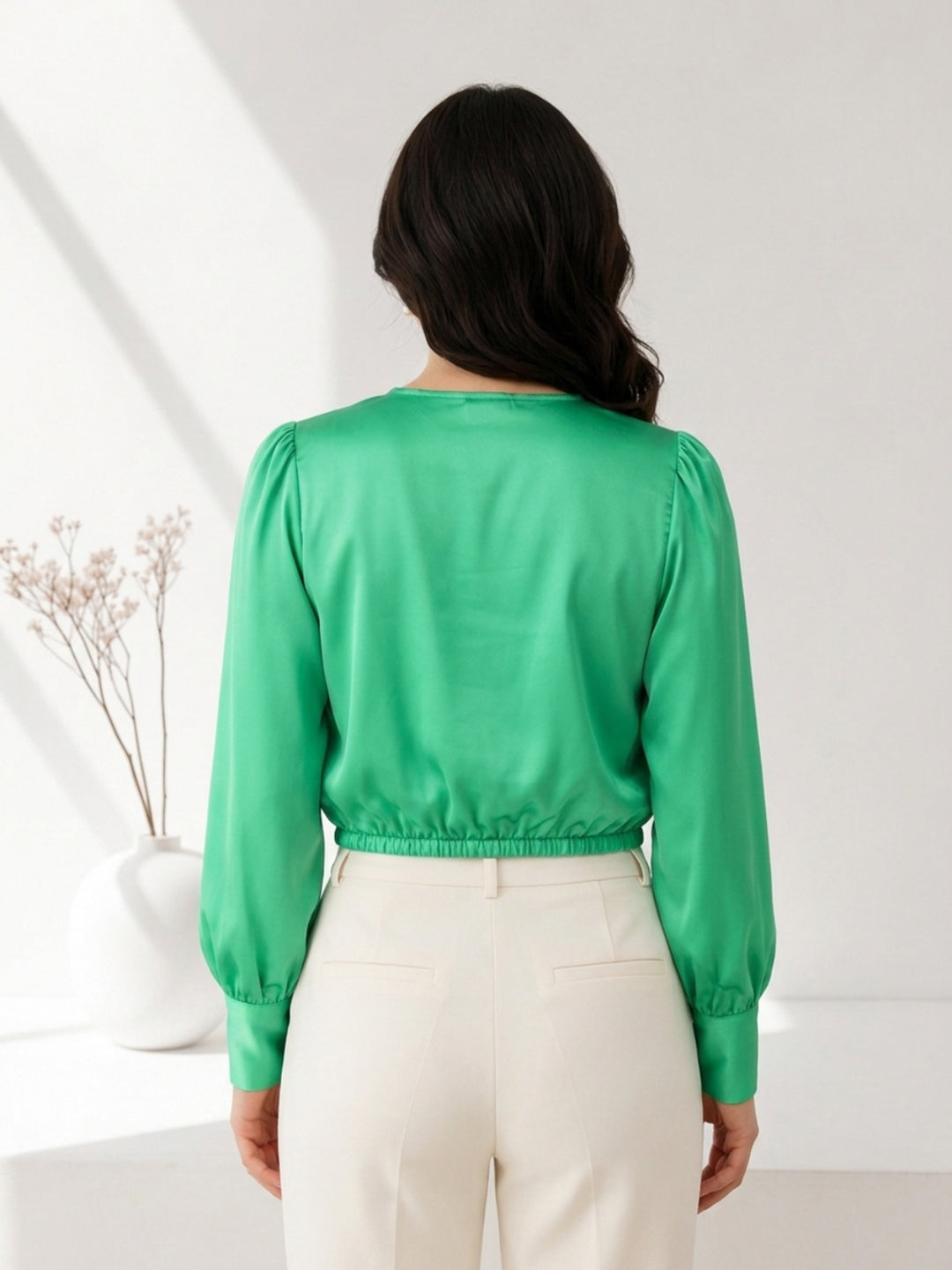 Green satin blouse with puff sleeves paired with white pants, stylish women's fashion