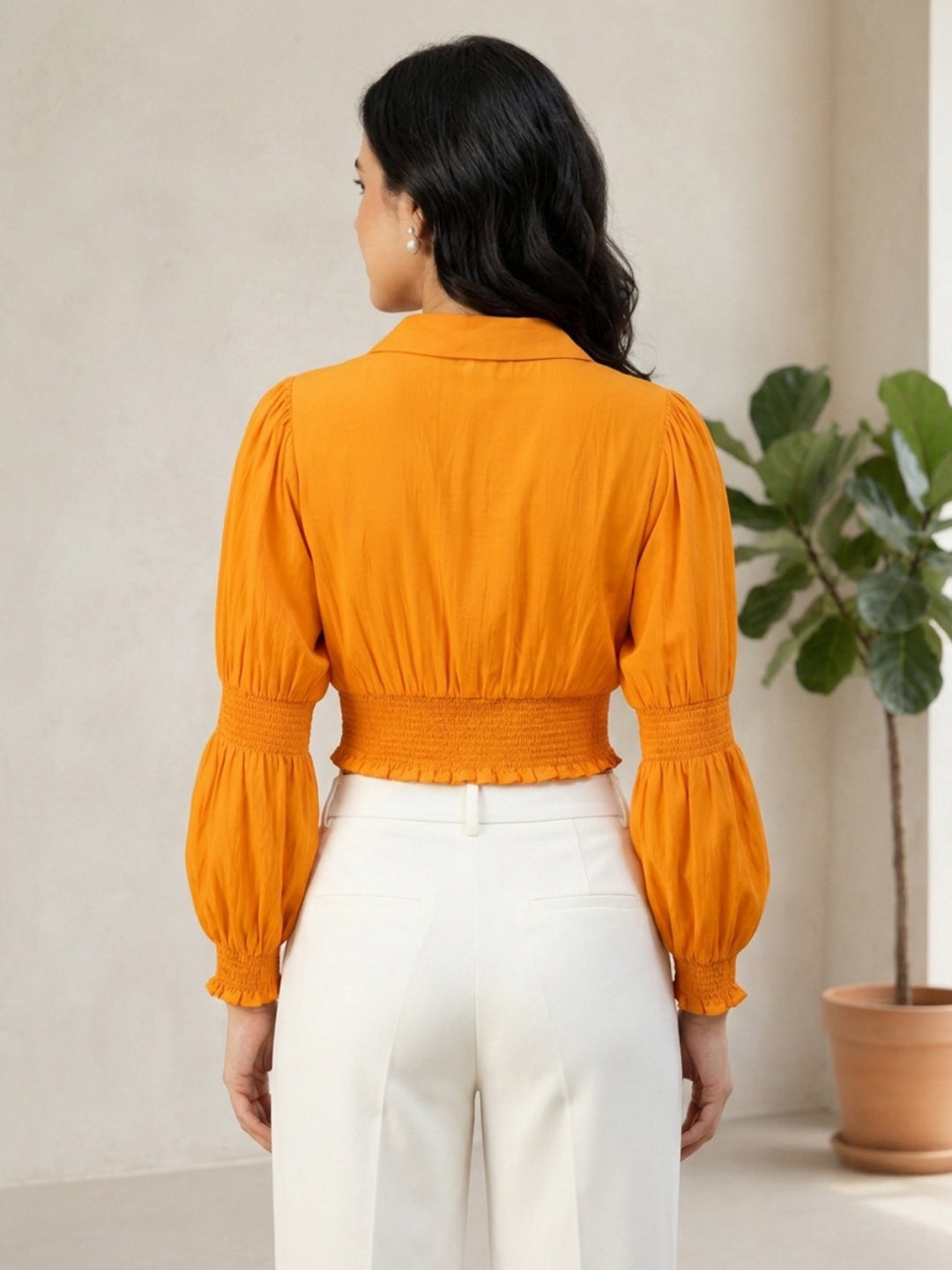 Orange cropped blouse with puff sleeves and smocked waist, paired with white pants for women's fashion