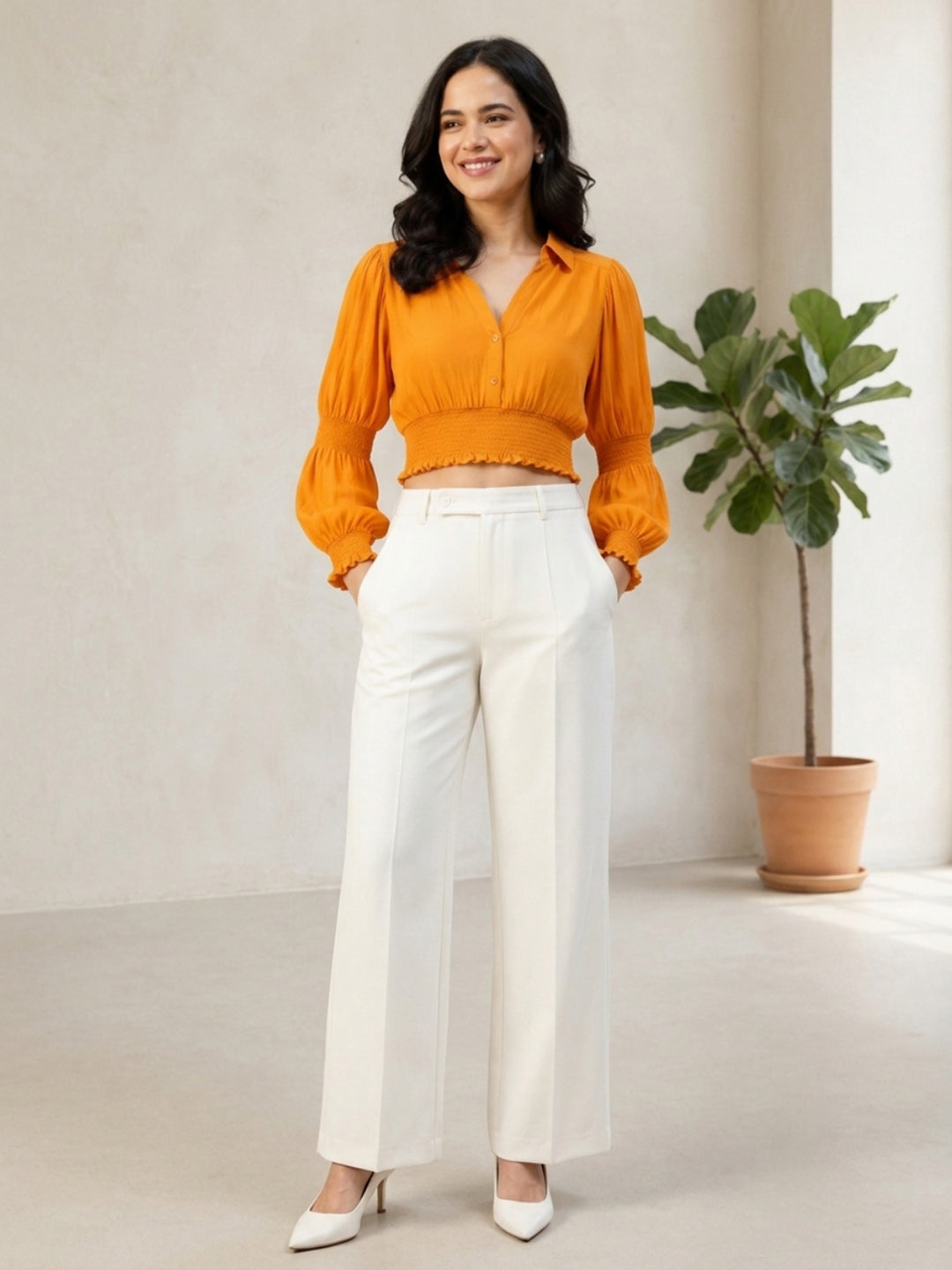 Woman in orange cropped blouse with puff sleeves and white wide-leg pants, stylish plus size outfit