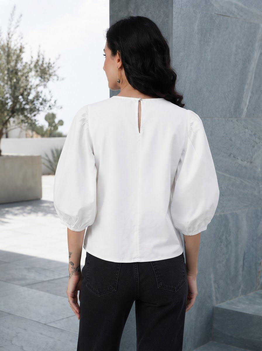 White puff sleeve blouse with back keyhole detail, paired with black jeans for casual women's fashion