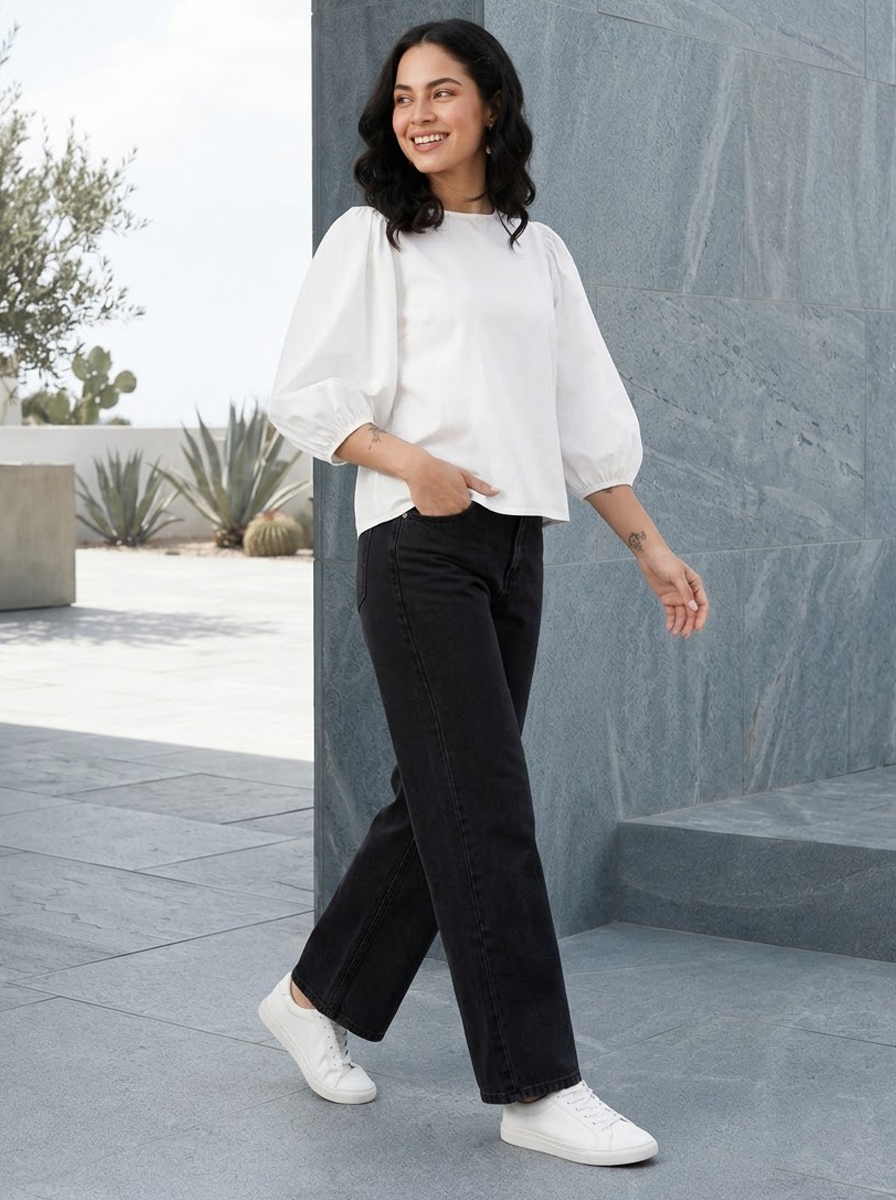 Woman in white puff sleeve top and black wide leg jeans, stylish plus size fashion outfit