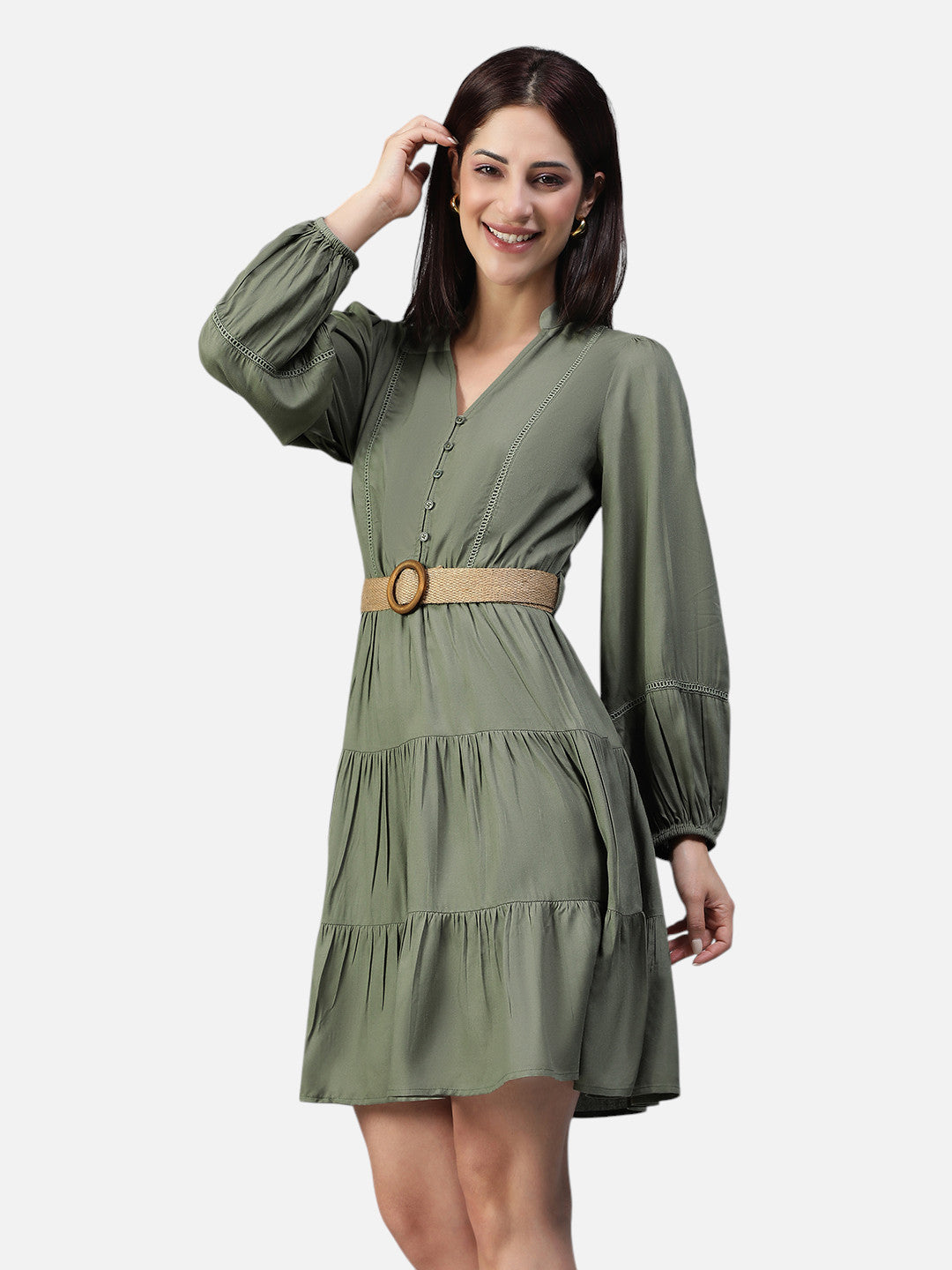 Woman wearing olive green belted A line dress with long sleeves and V neck, posing and smiling