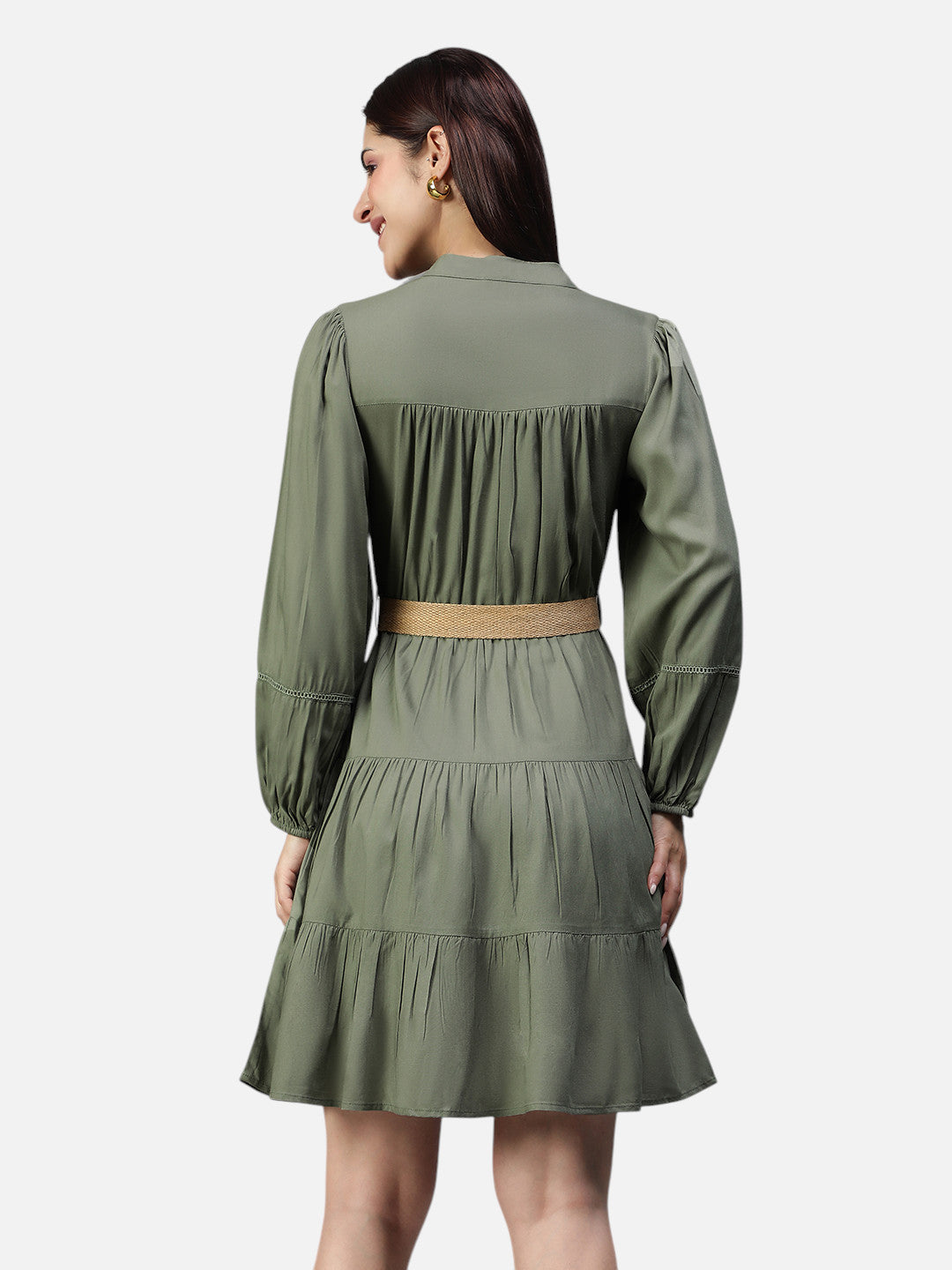 Woman in olive green long sleeve belted dress, back view, against white background