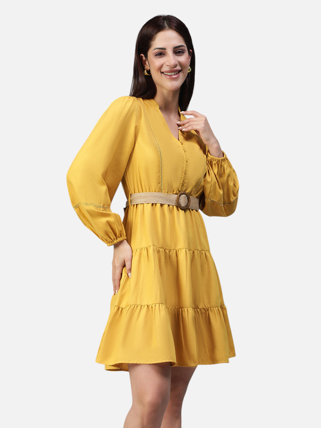 Woman wearing a yellow belted tiered mini dress with long sleeves