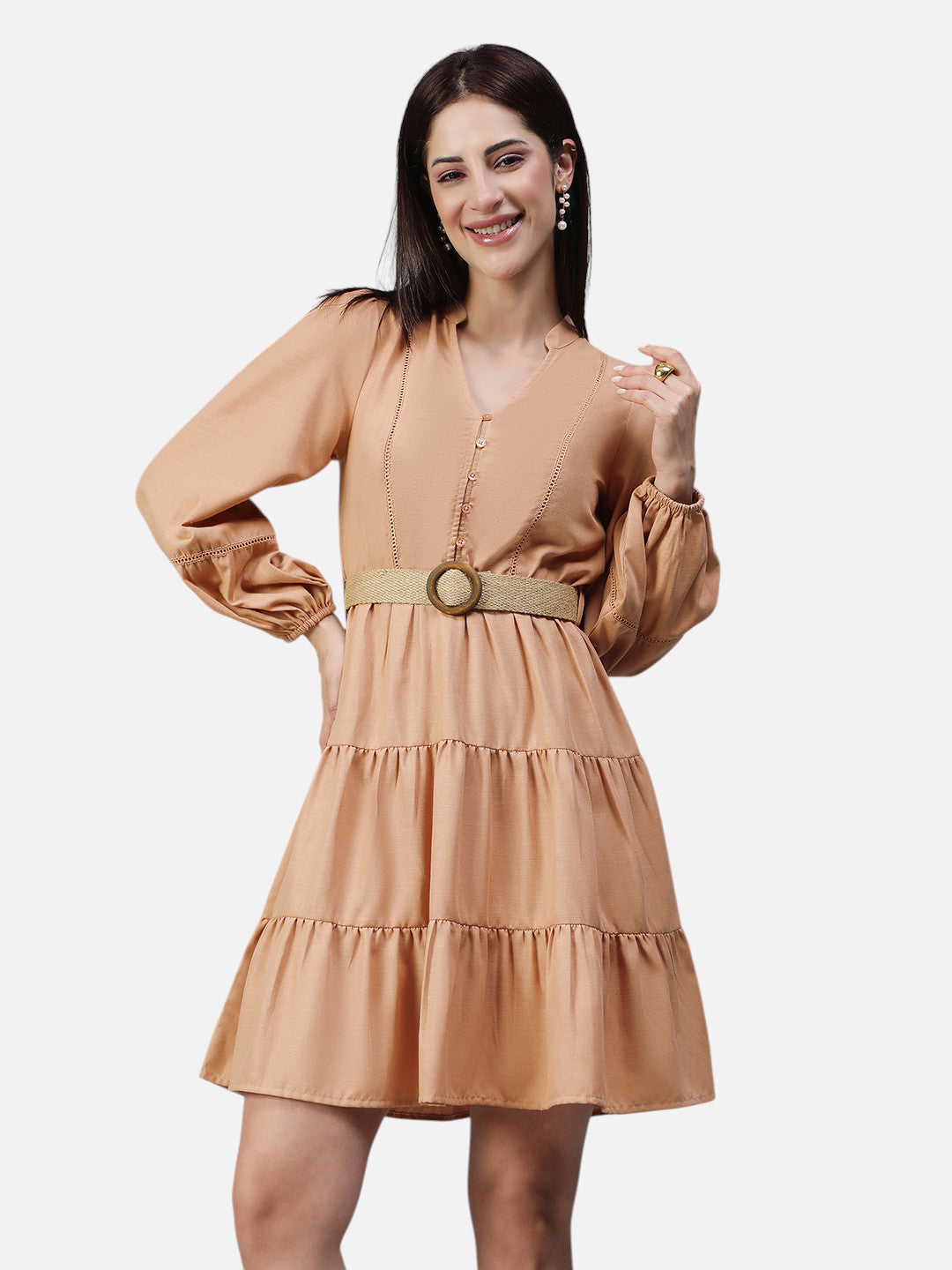 Woman wearing peach tiered mini dress with bishop sleeves and a belted waist