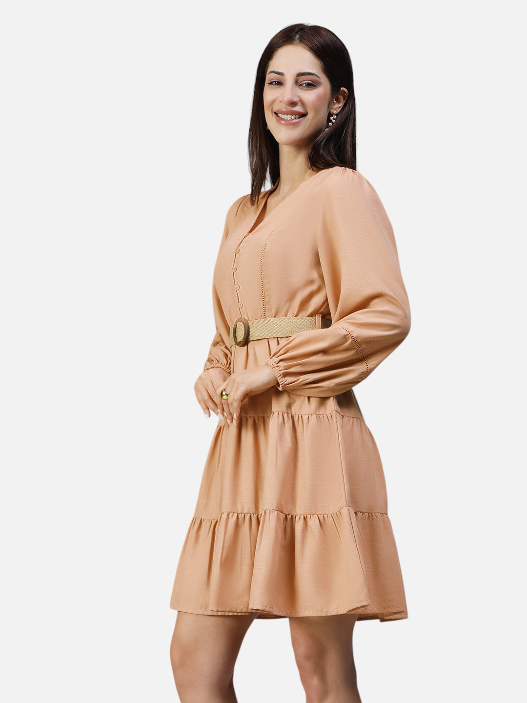 Woman wearing peach belted A-line mini dress with long sleeves and button details