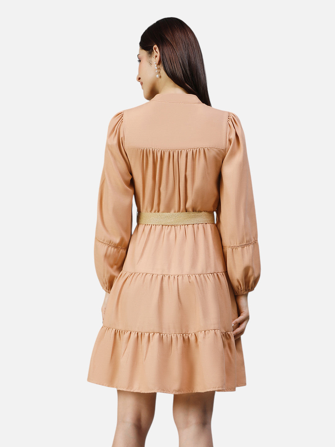Woman wearing peach long sleeve tiered mini dress, back view, against white background