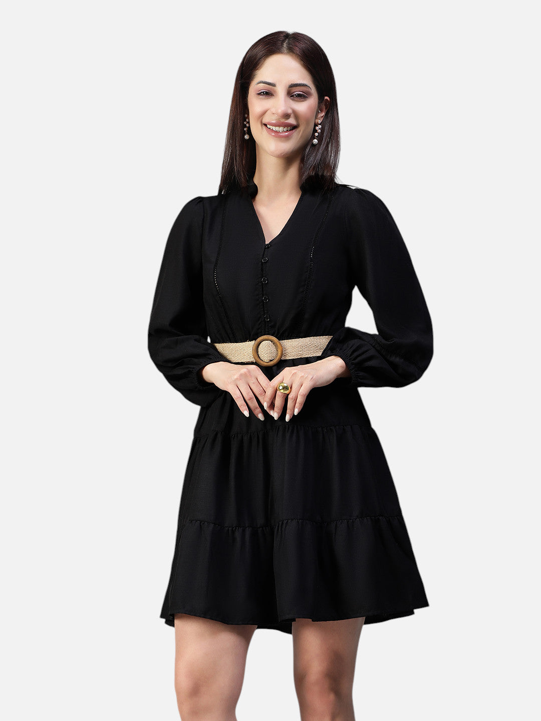 Woman wearing a black long sleeve V-neck mini dress with ruffle skirt and beige belt