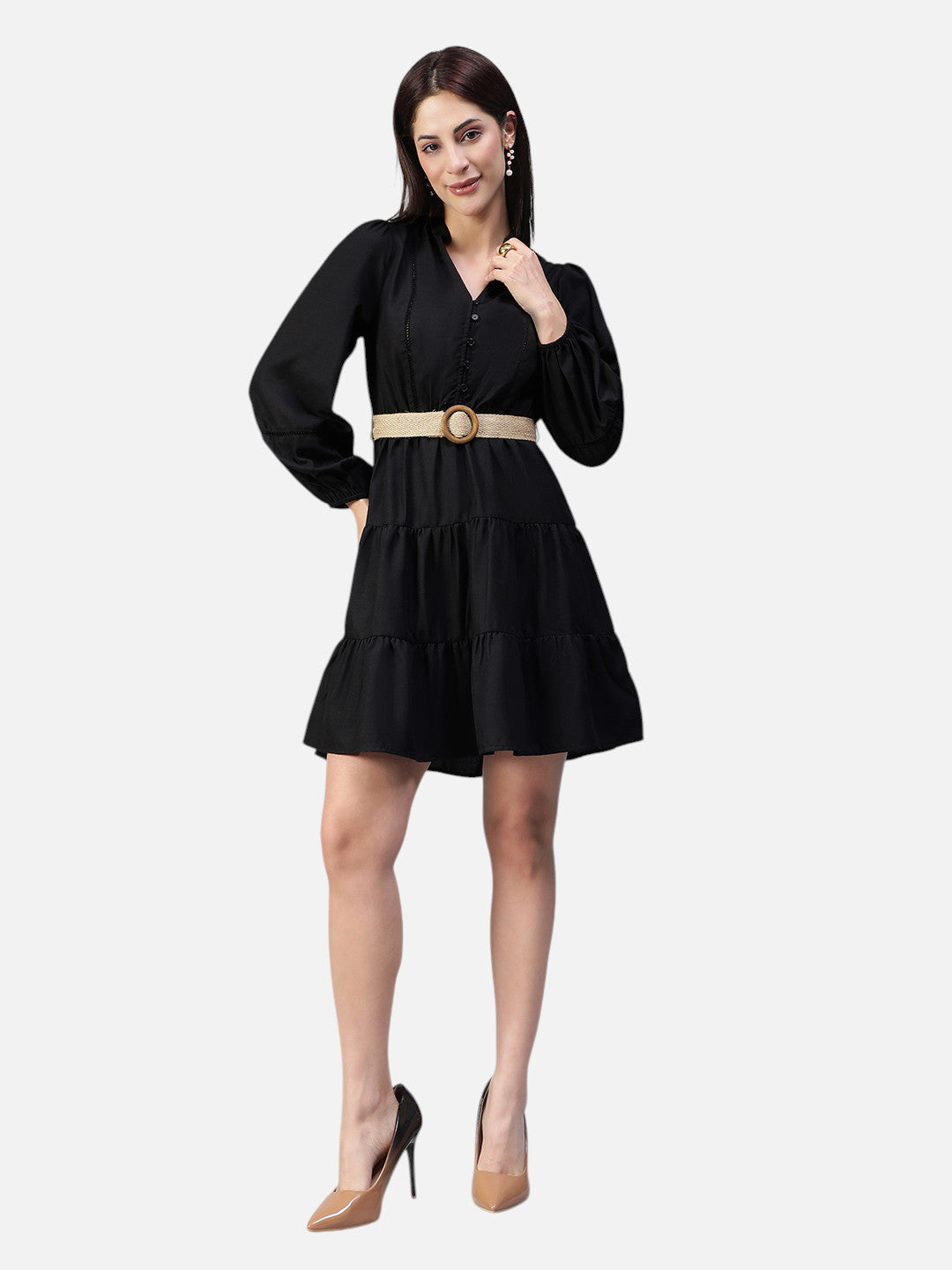 Woman wearing a black long sleeve mini dress with tiered skirt and beige belt