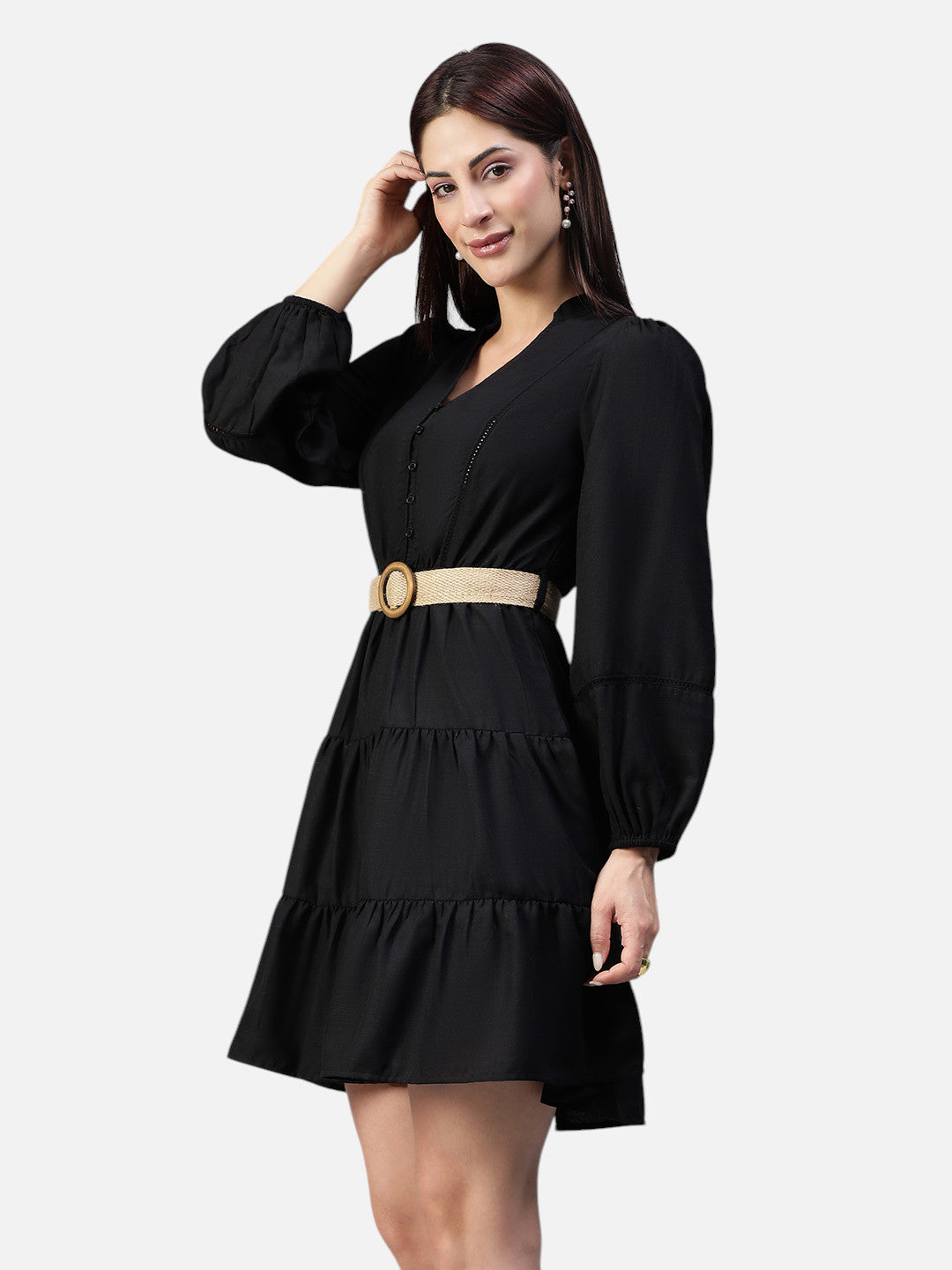 Woman wearing a black tiered mini dress with long sleeves and a beige belt, fashion clothing