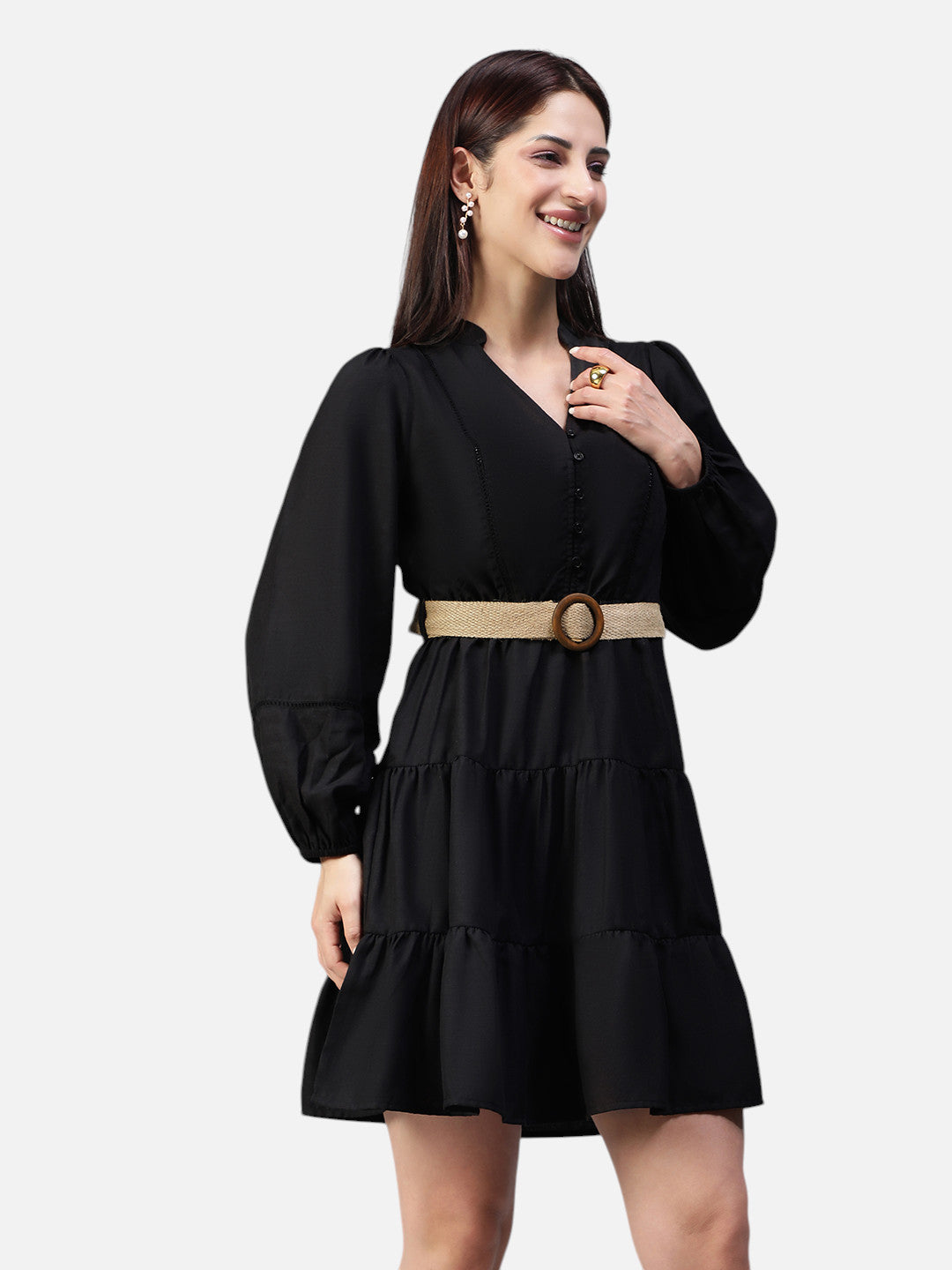 Woman wearing a black long sleeve tiered mini dress with a tan belt, fashion clothing