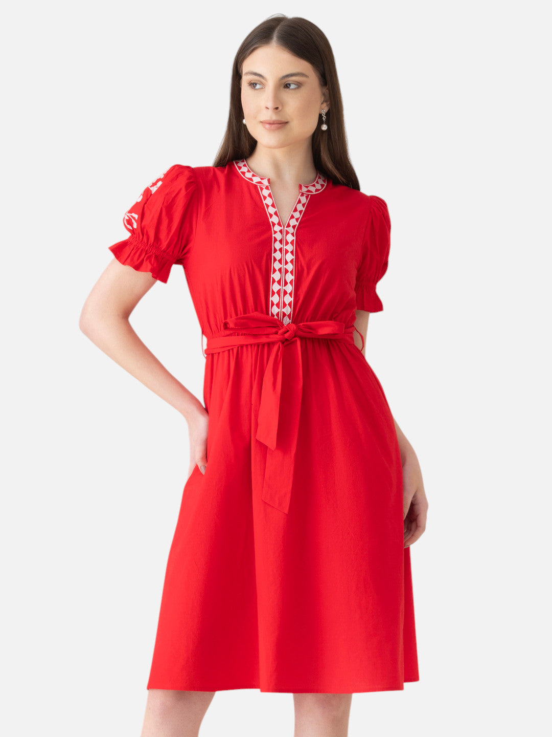 Woman in red knee-length dress with puff sleeves, printed V-neck, and waist tie, stylish summer fashion