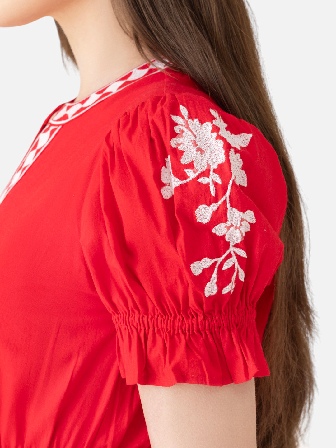 Red puff sleeve dress with white floral embroidery on the shoulder and patterned neckline