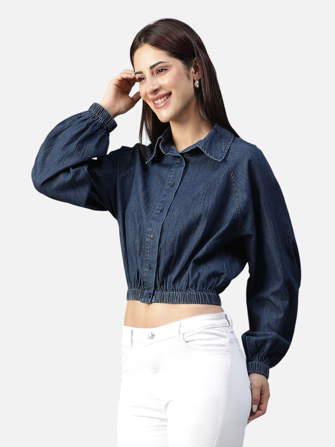 Woman wearing a blue denim crop shirt with long sleeves and white pants, fashion clothing