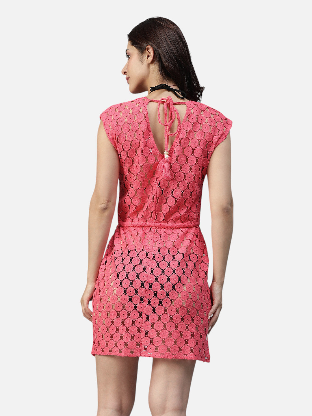 Back view of woman in pink lace mini dress with keyhole back and tie detail