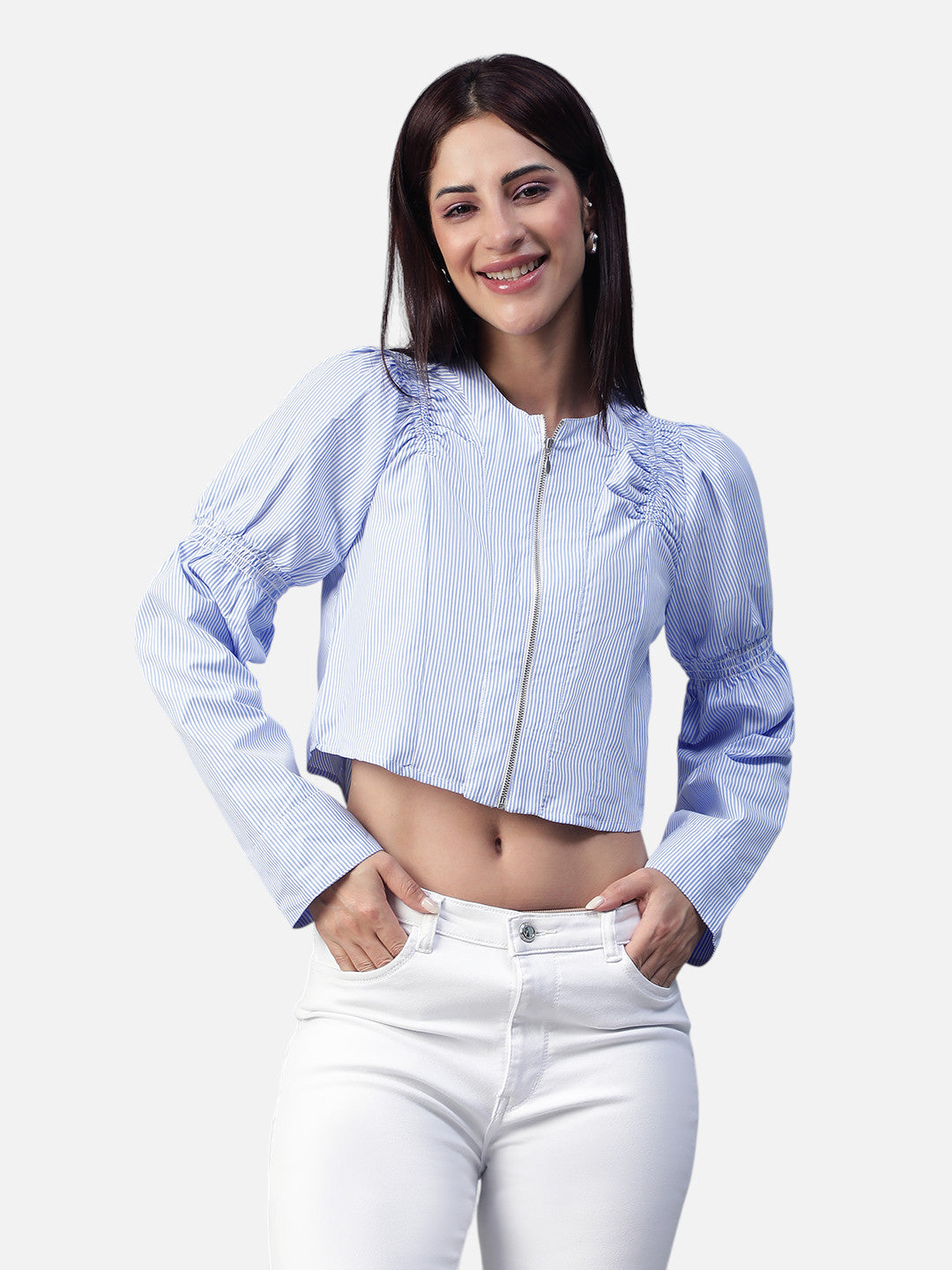 Woman wearing a light blue striped cropped top and white jeans, front view