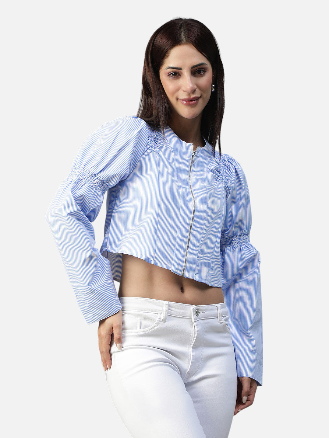Woman wearing a light blue striped crop jacket with puff sleeves and white jeans