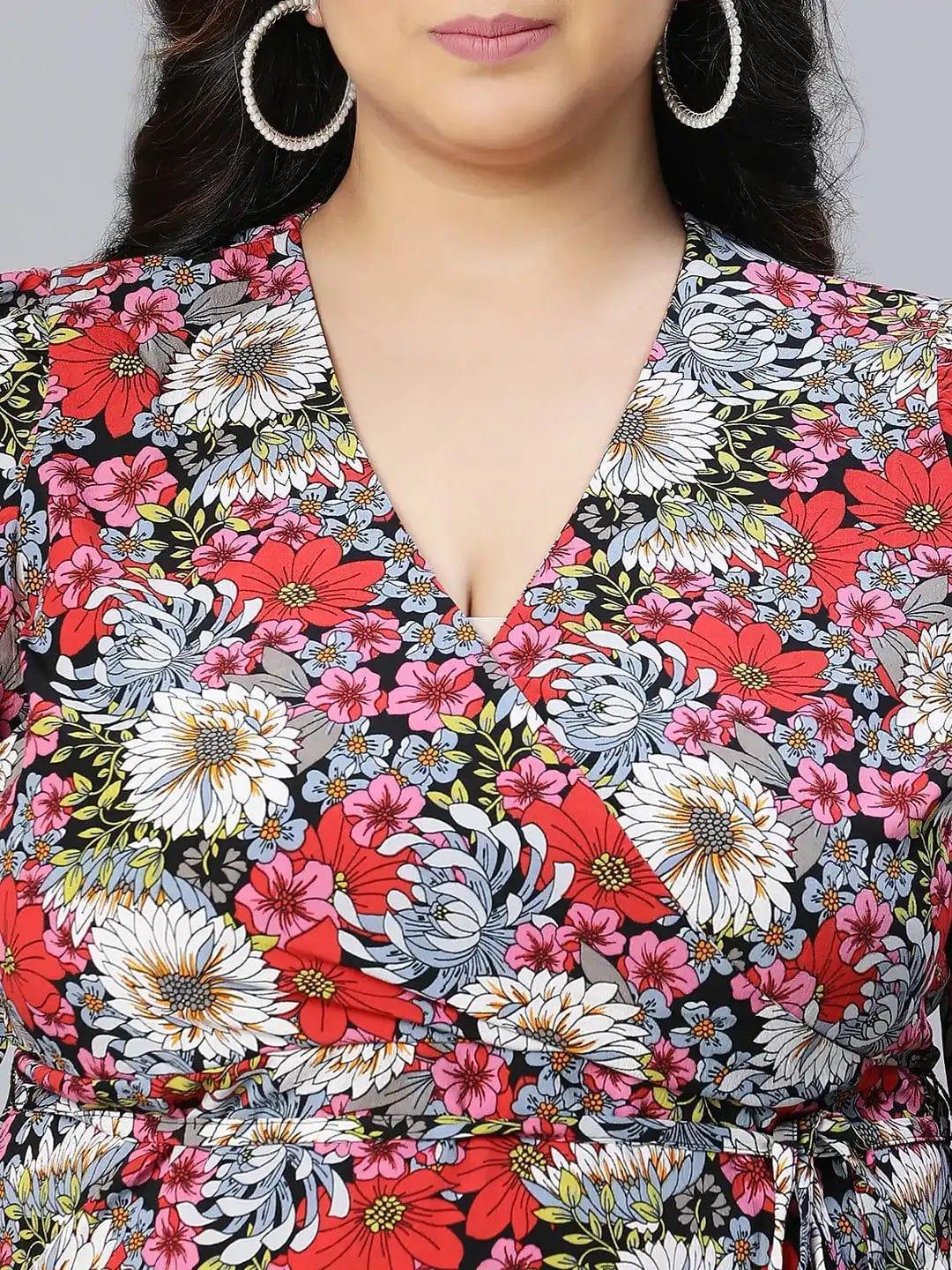 A woman wearing a floral print dress and white sandals is posing for a photograph.