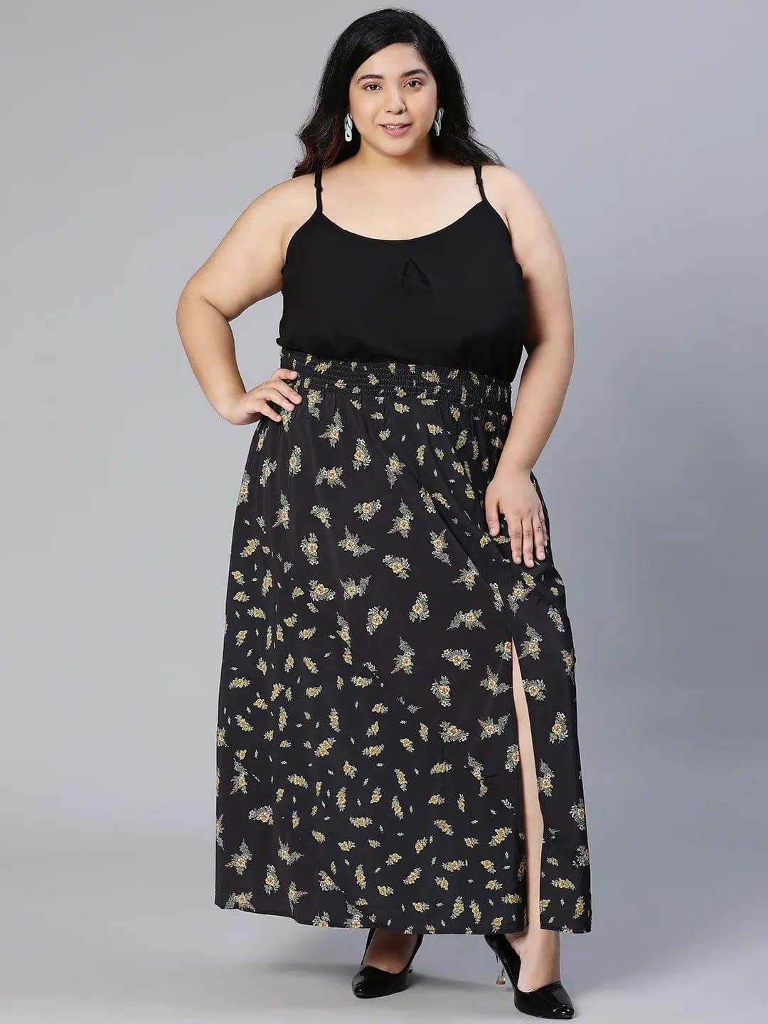 A woman wearing a black skirt with a floral print pattern.
