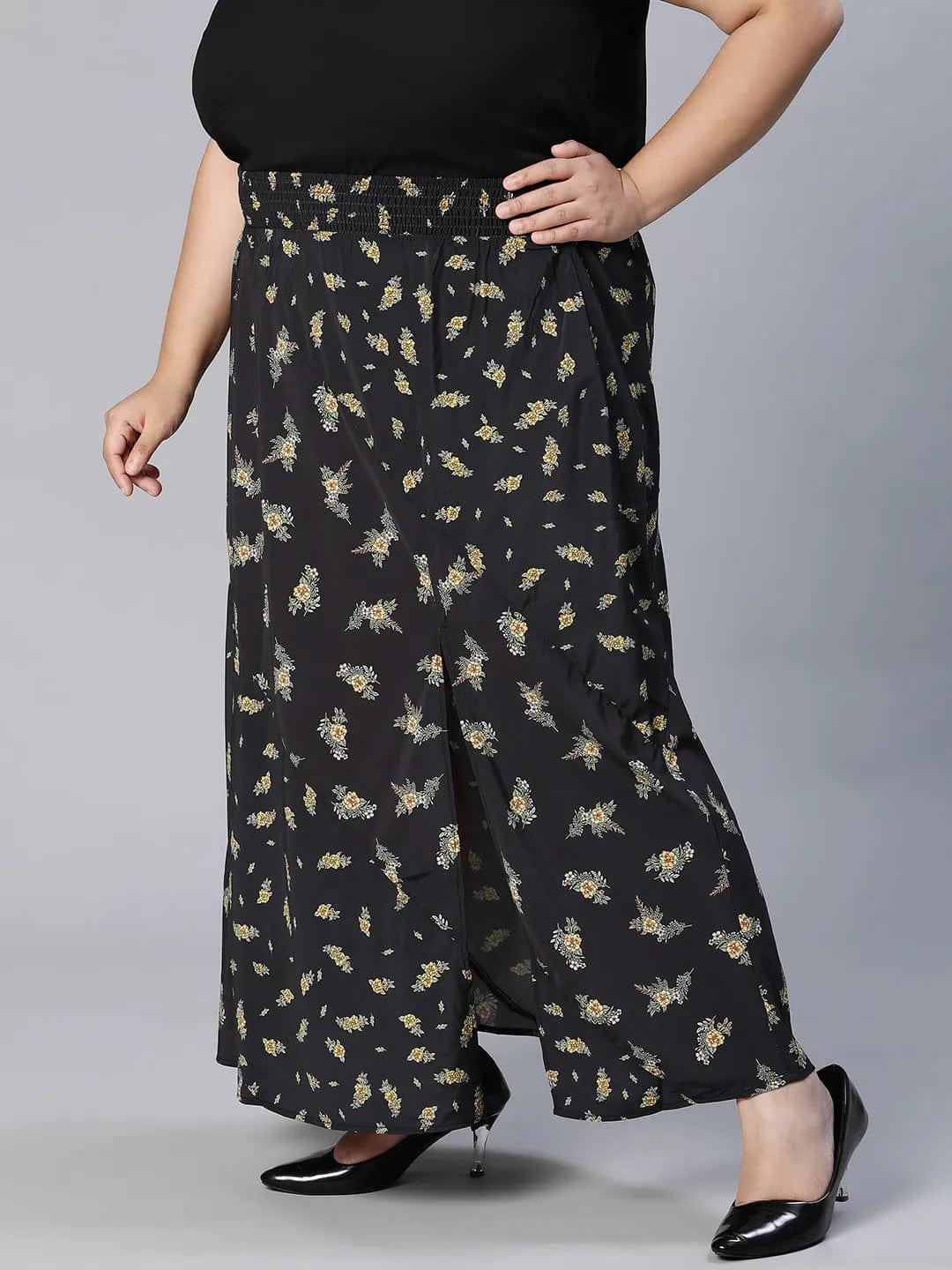 A woman wearing a black skirt with a floral print pattern.