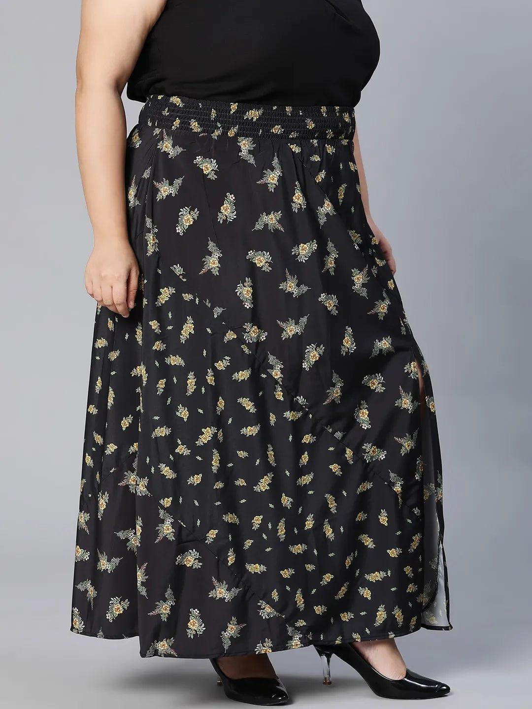 A woman wearing a black skirt with a floral print pattern.