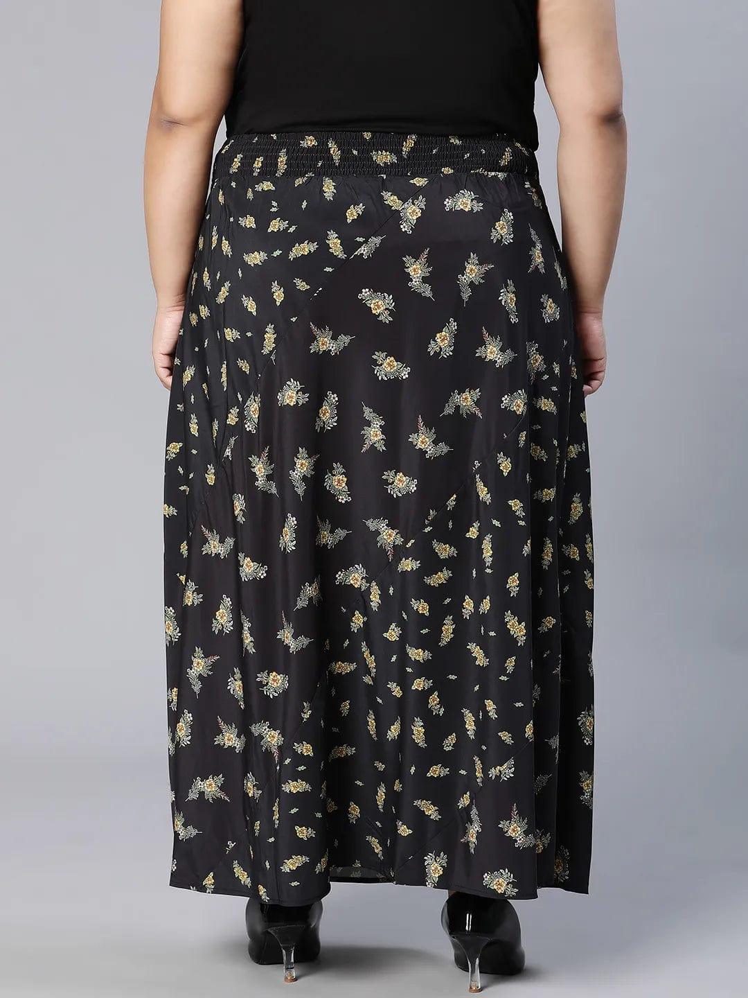 A woman wearing a black skirt with a floral print pattern.