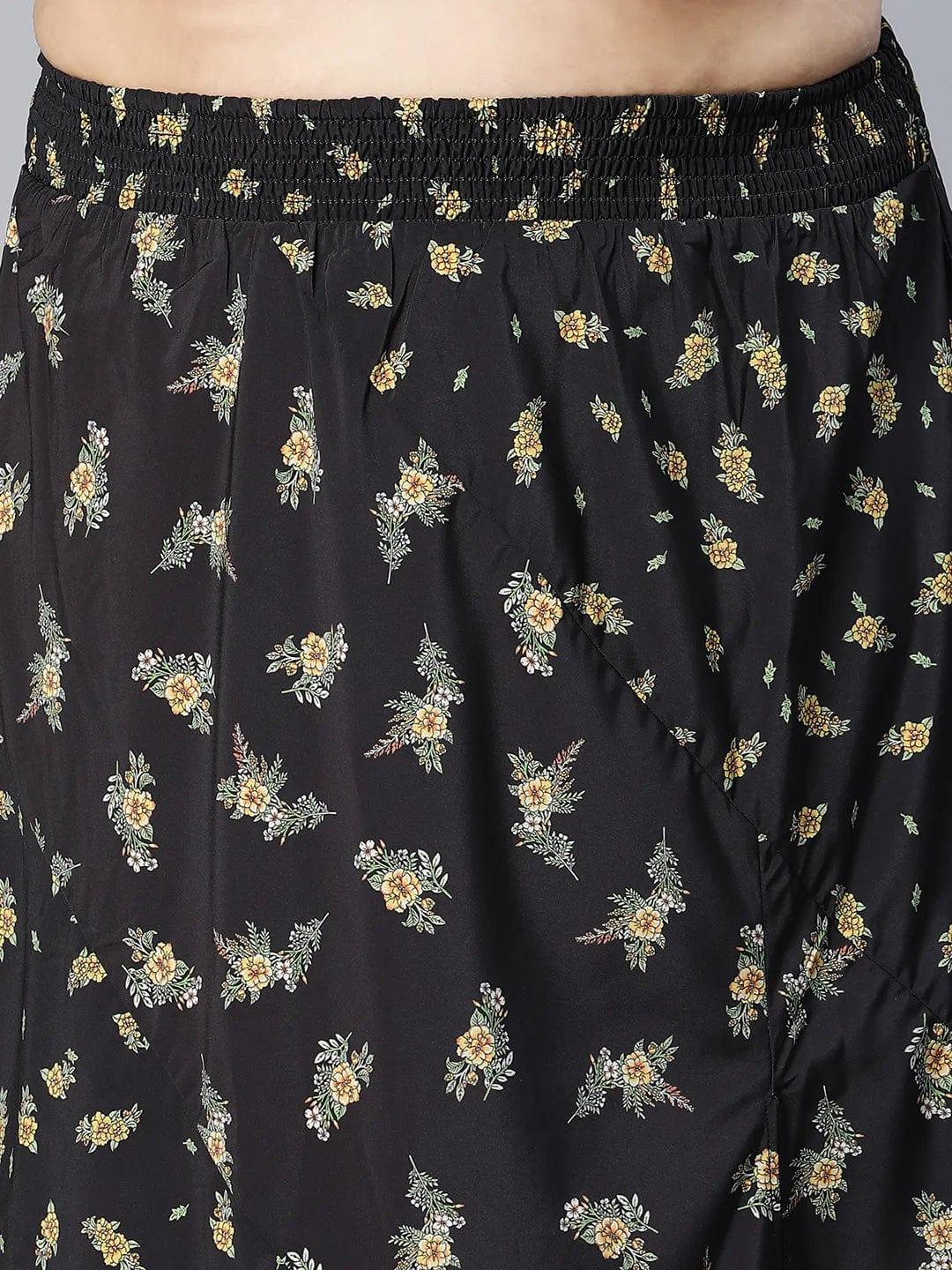 A woman wearing a black skirt with a floral print pattern.