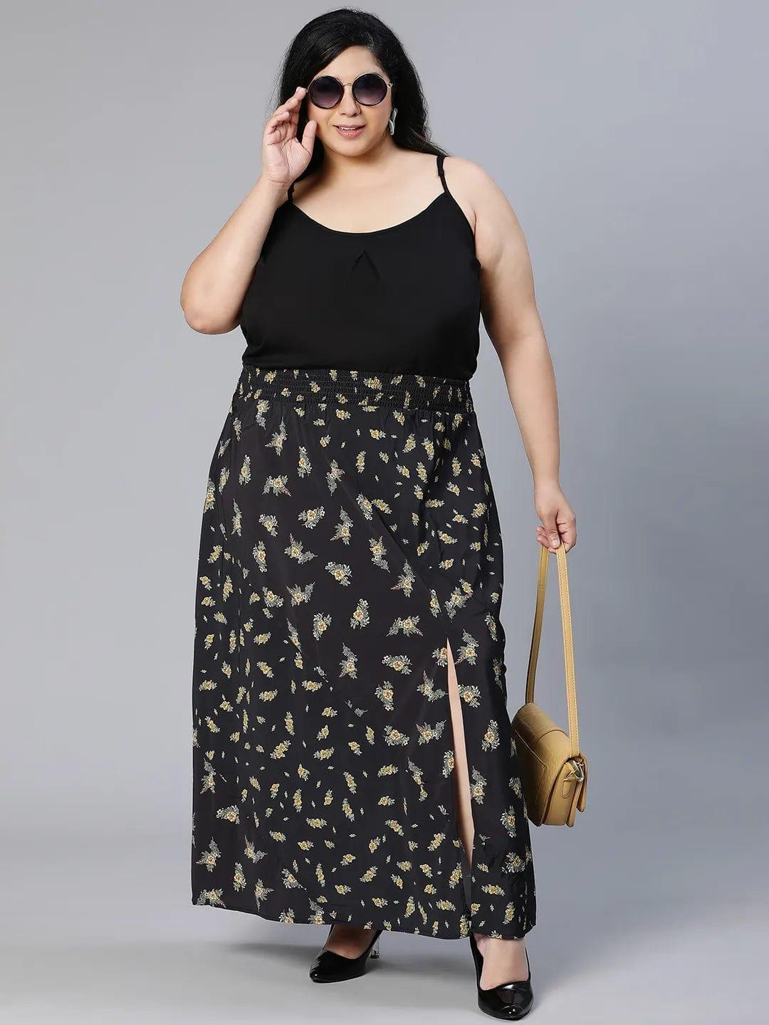 A woman wearing a black skirt with a floral print pattern.
