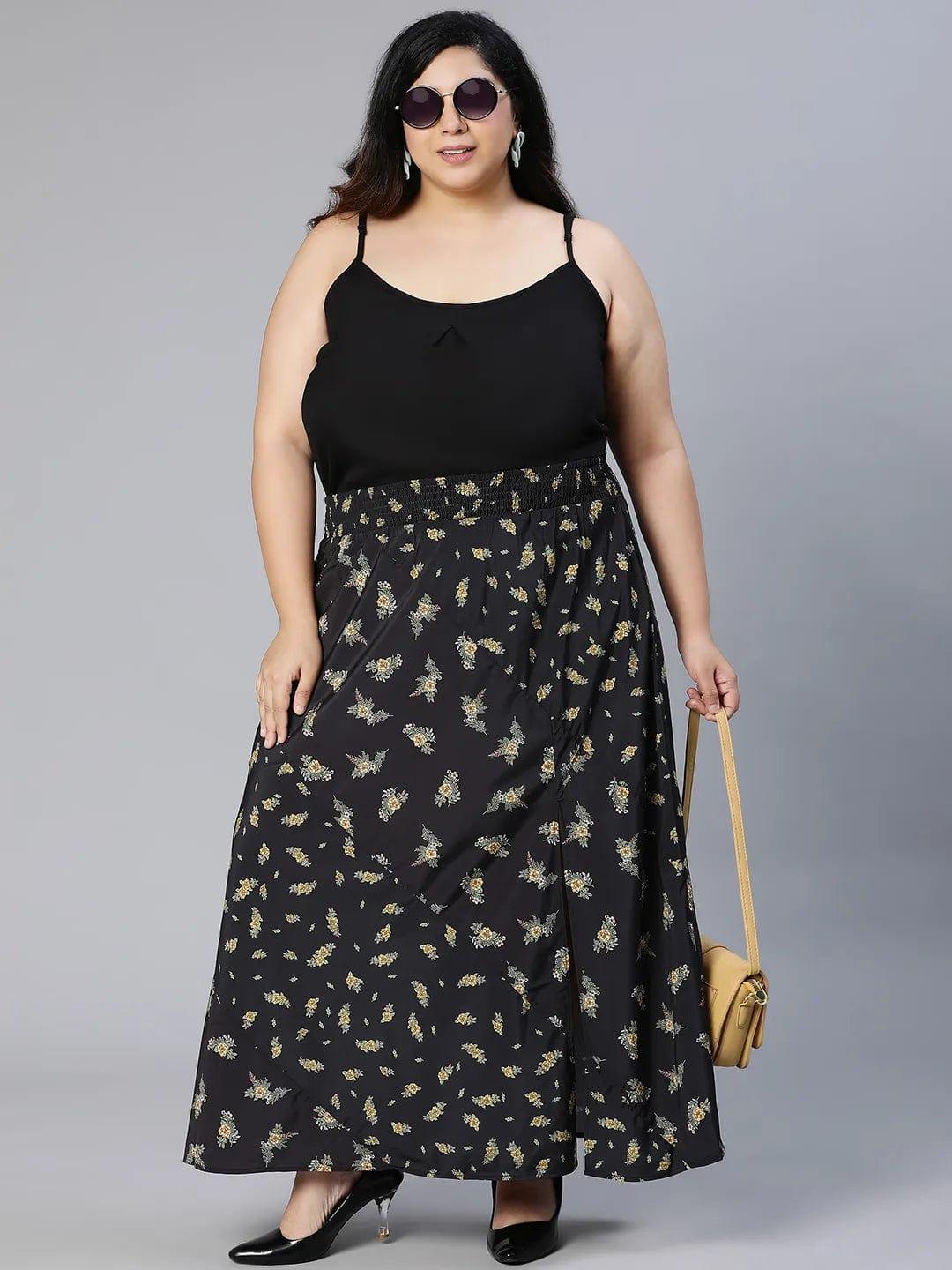 A woman wearing a black skirt with a floral print pattern.