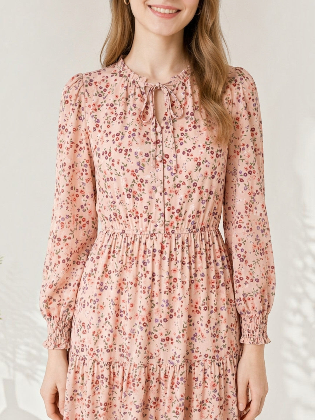 Pink floral dress with long sleeves and tie neck, perfect for women's fashion