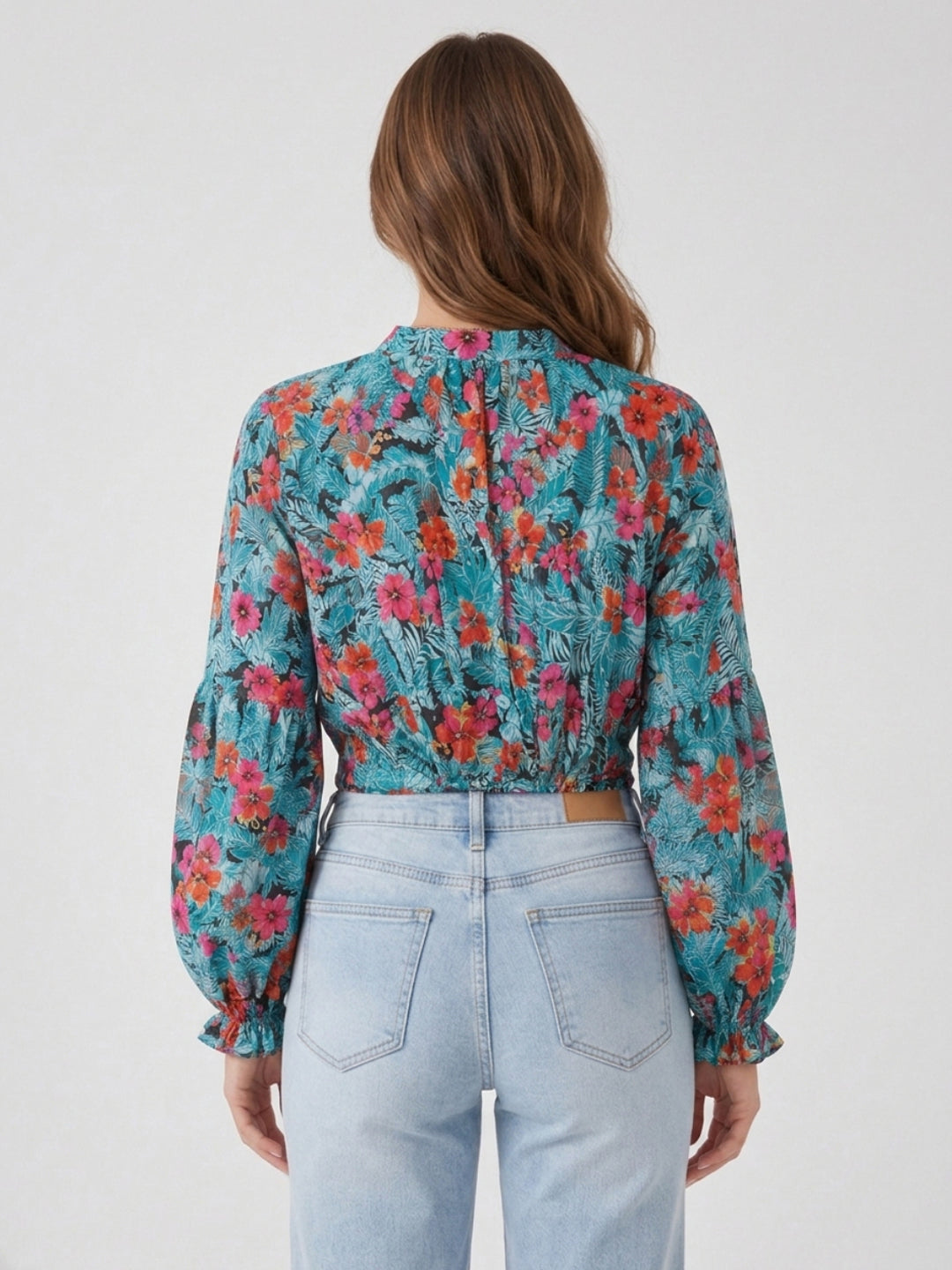 Floral print blouse with puff sleeves, back view, paired with light wash jeans for women's fashion