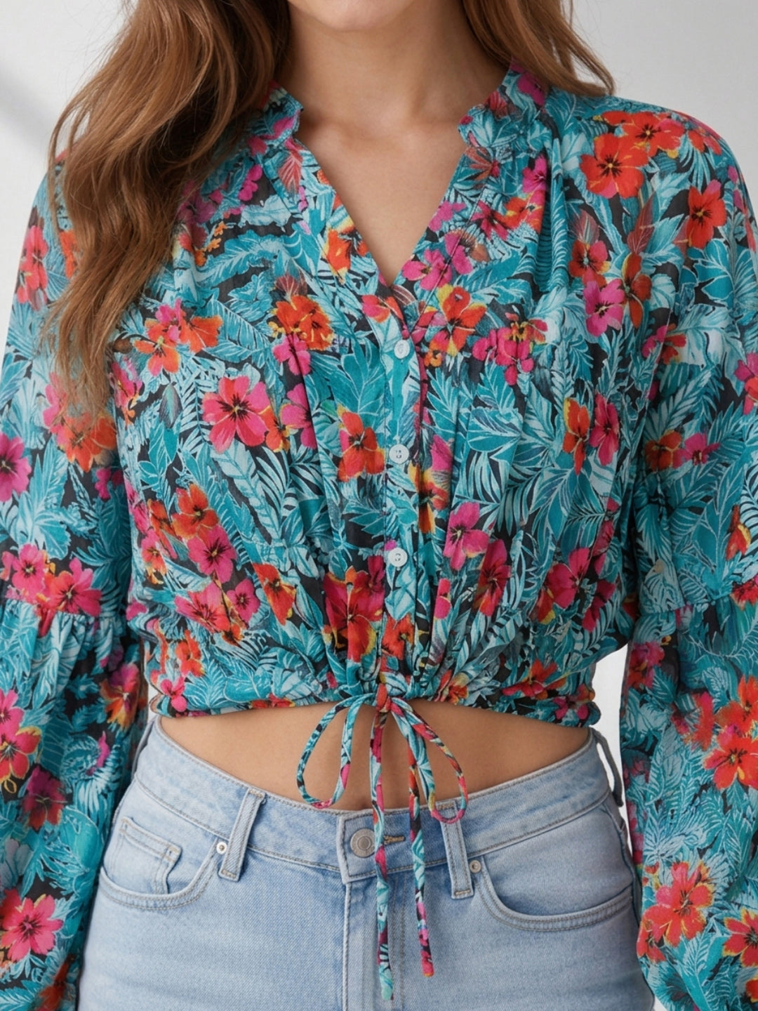 Tropical floral crop top with tie-front detail, long sleeves, and vibrant hibiscus print for women's fashion