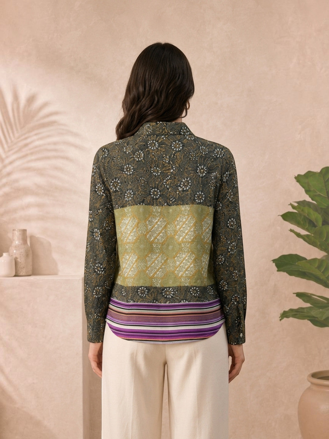 Woman wearing floral and geometric patterned long sleeve blouse with striped hem, plus size fashion