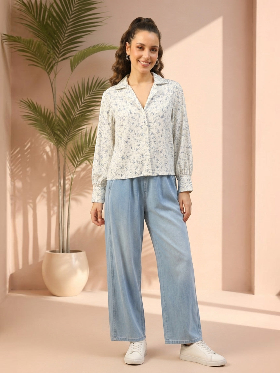 Woman in floral blouse and wide-leg denim pants, stylish plus size fashion outfit