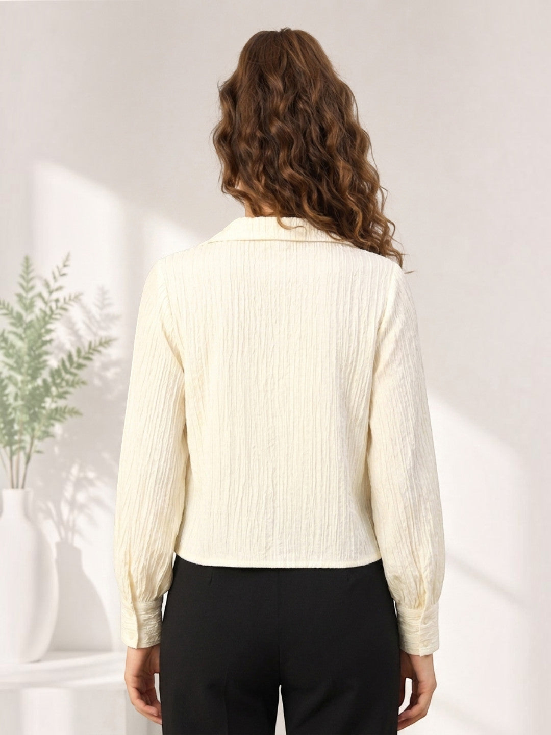 Cream textured long sleeve blouse for women, back view with black pants, stylish office wear
