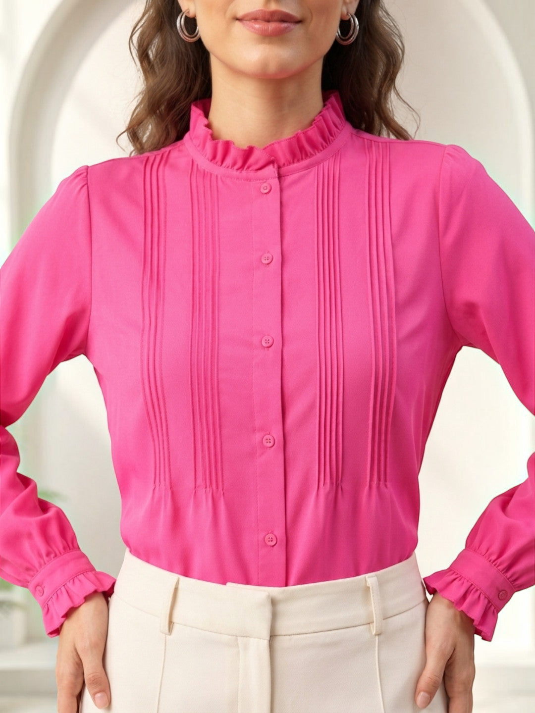 Pink pleated button-up blouse with ruffled collar and cuffs, styled with cream pants for women's fashion